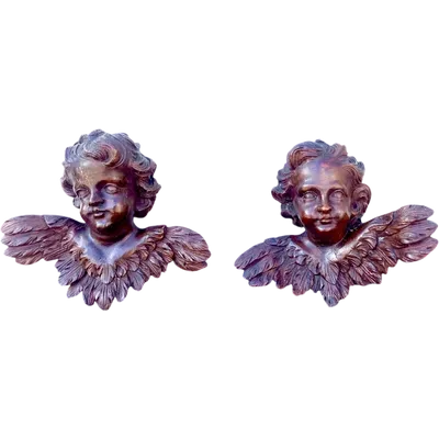 Pair of carved wooden cherubs with a marbled finish. Liguria.