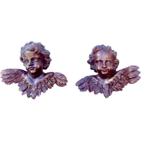 Pair of carved wooden cherubs with a marbled finish. Liguria.