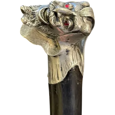 A walking stick with a solid silver knob depicting the head of Mephistopheles turned to one side.