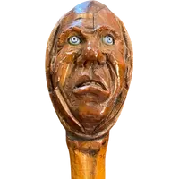 Cane with a curozo seed knob depicting a grotesque face. Glass eyes