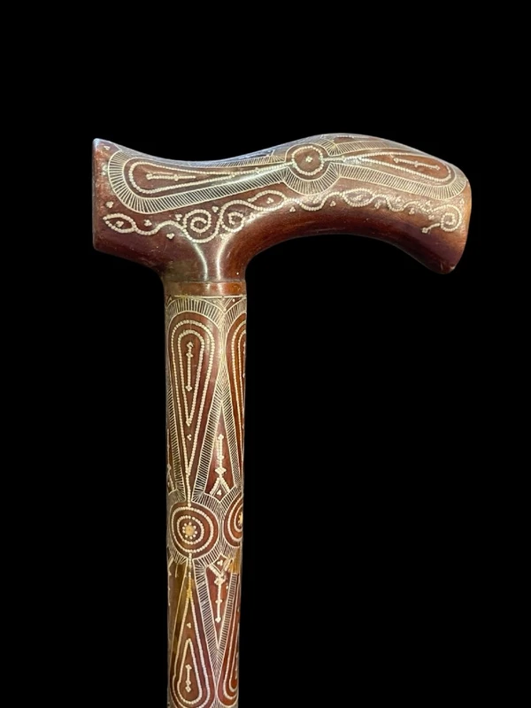 Rosewood walking stick with a Tau-shaped handle featuring geometric decoration in small silver studs