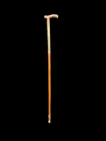 Rosewood walking stick with a Tau-shaped handle featuring geometric decoration in small silver studs
