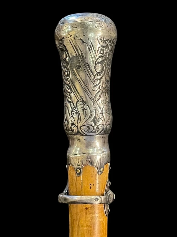 "Compagnon" ceremonial cane in silver with stylized floral and geometric motifs.