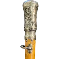 "Compagnon" ceremonial cane in silver with stylized floral and geometric motifs.