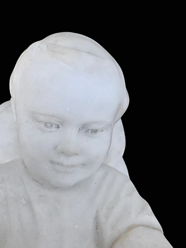 A sculpture in white Carrara marble depicting a mother holding cherries and her child.