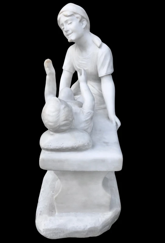 A sculpture in white Carrara marble depicting a mother holding cherries and her child.