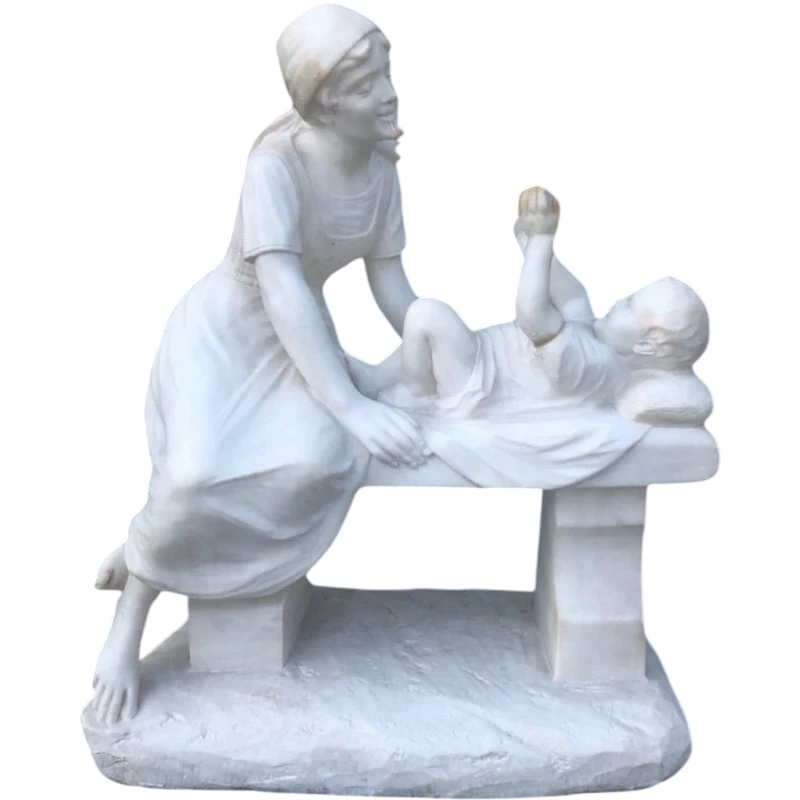 A sculpture in white Carrara marble depicting a mother holding cherries and her child.