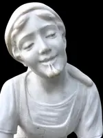 A sculpture in white Carrara marble depicting a mother holding cherries and her child.