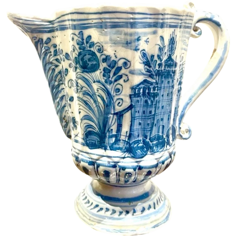 Majolica pitcher with a three-lobed spout, a handle featuring a serpentine motif, and a globular body