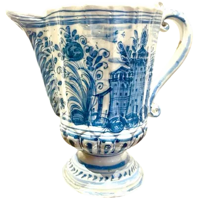 Majolica pitcher with a three-lobed spout, a handle featuring a serpentine motif, and a globular body