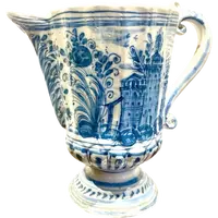 Majolica pitcher with a three-lobed spout, a handle featuring a serpentine motif, and a globular body