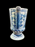 Majolica pitcher with a three-lobed spout, a handle featuring a serpentine motif, and a globular body