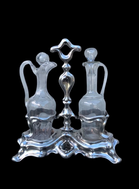 Silver oil cruet with embossed Art Nouveau motifs. Minerva hallmark. France.