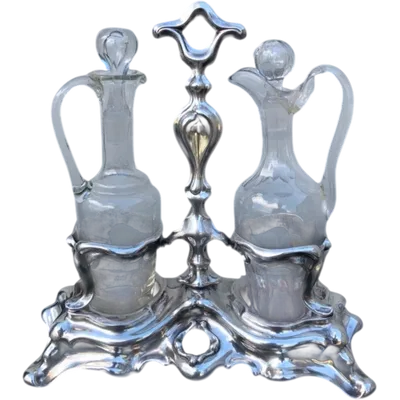 Silver oil cruet with embossed Art Nouveau motifs. Minerva hallmark. France.