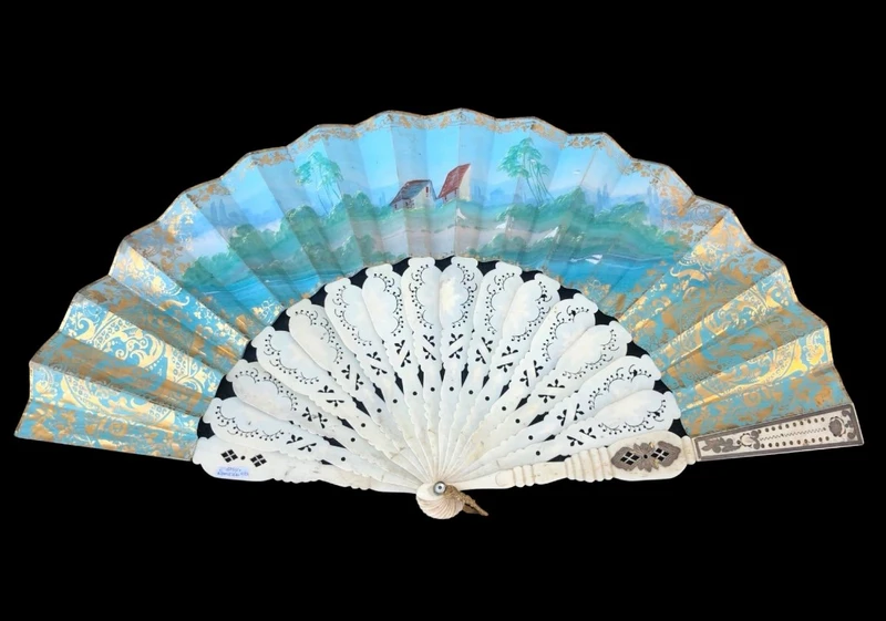 Fan with openwork, gilded bone ribs. Paper cover with watercolor prints