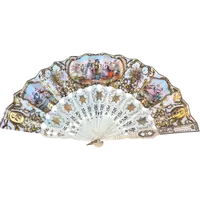 Fan with openwork, gilded bone ribs. Paper cover with watercolor prints