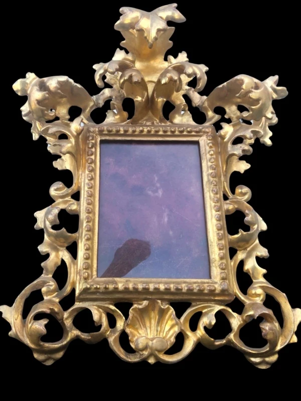 Rectangular box frame made of carved, openwork wood with gold leaf. Florence.