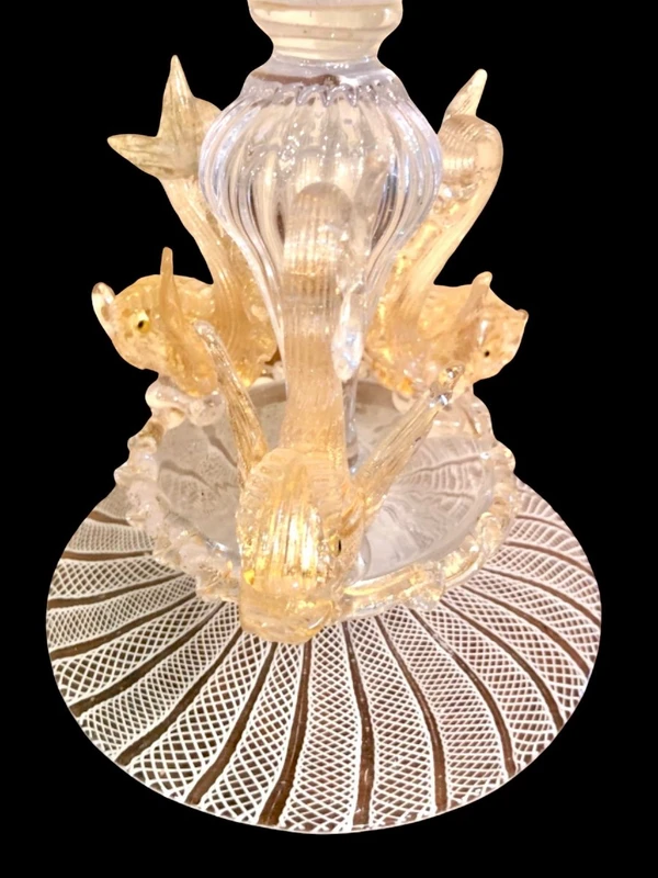 A bowl-shaped vase made of zanfirico glass with gold inclusions, featuring three dolphins on the base. Fratelli Toso.