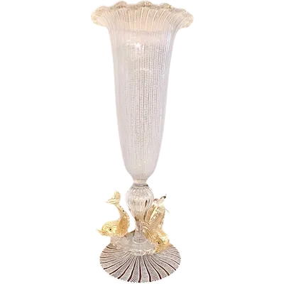 A bowl-shaped vase made of zanfirico glass with gold inclusions, featuring three dolphins on the base. Fratelli Toso.