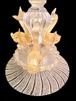 A bowl-shaped vase made of zanfirico glass with gold inclusions, featuring three dolphins on the base. Fratelli Toso.