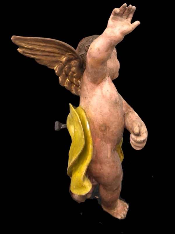 Polychrome carved wooden sculpture depicting an angel with outstretched wings. Liguria.