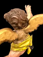 Polychrome carved wooden sculpture depicting an angel with outstretched wings. Liguria.