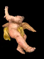 Polychrome carved wooden sculpture depicting an angel with outstretched wings. Liguria.