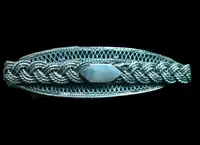 Silver filigree card holder featuring plant motifs and stylized scrolls.