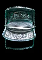 Silver filigree card holder featuring plant motifs and stylized scrolls.