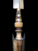 A globular-shaped pipe made of sea foam and silver with geometric patterns. Horn mouthpiece