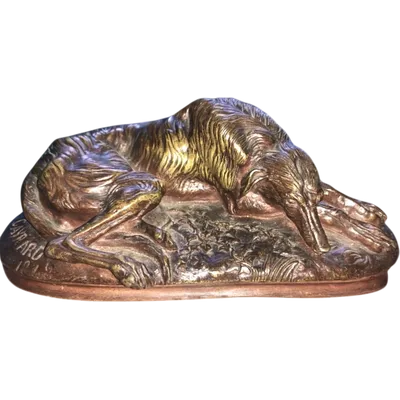 Bronze sculpture on a marble base depicting a sleeping greyhound. Signed