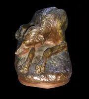 Bronze sculpture on a marble base depicting a sleeping greyhound. Signed