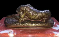 Bronze sculpture on a marble base depicting a sleeping greyhound. Signed