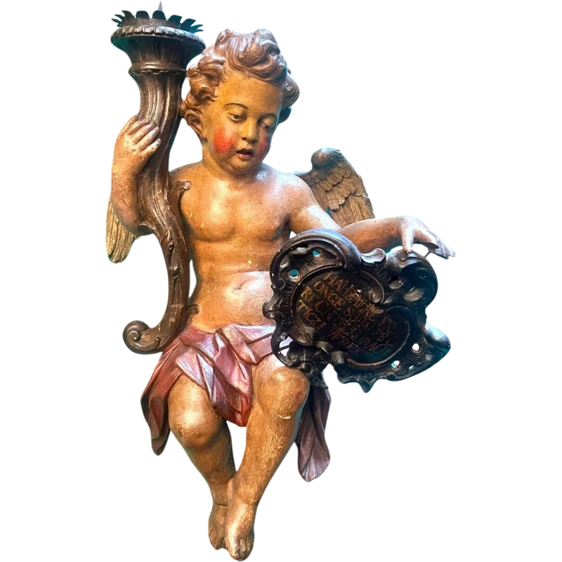 Polychrome wooden sculpture depicting an angel holding a candlestick and a rocaille shield