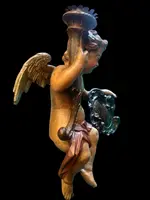 Polychrome wooden sculpture depicting an angel holding a candlestick and a rocaille shield