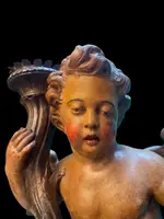 Polychrome wooden sculpture depicting an angel holding a candlestick and a rocaille shield