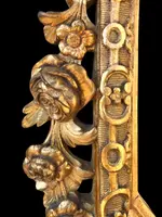 Frame - a carved and gilded wooden mirror featuring floral and rocaille motifs.