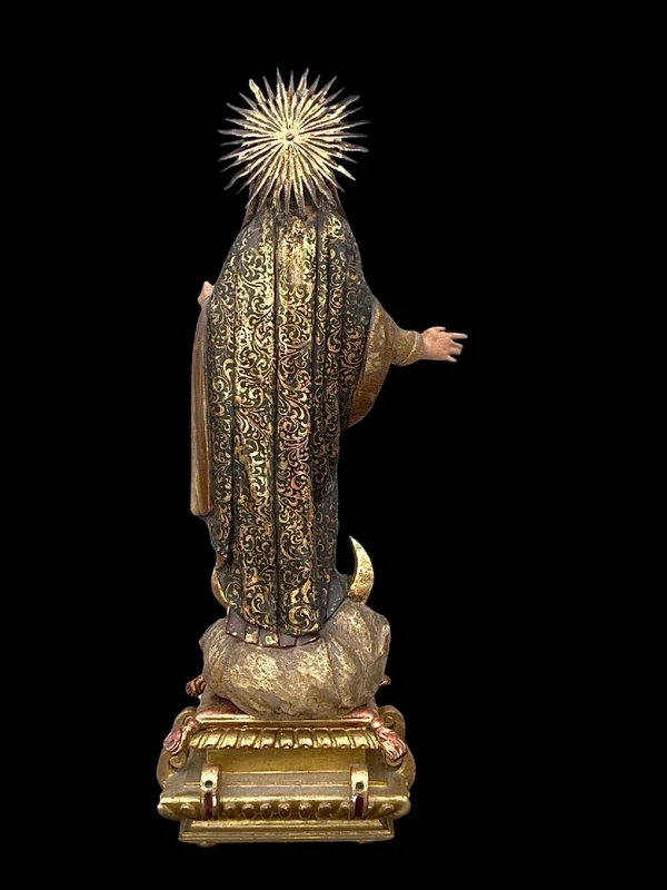Polychrome wooden sculpture with gold highlights; Madonna wearing a silver crown. Liguria.
