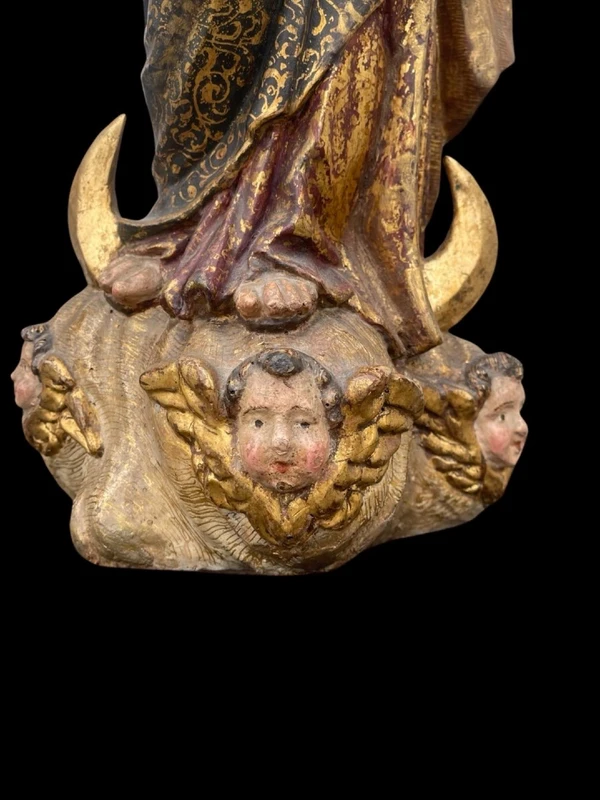 Polychrome wooden sculpture with gold highlights; Madonna wearing a silver crown. Liguria.