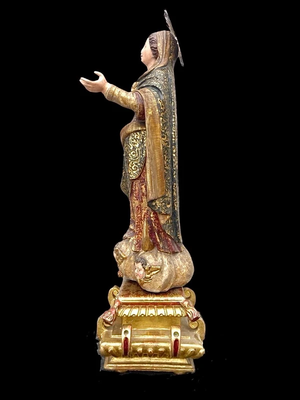 Polychrome wooden sculpture with gold highlights; Madonna wearing a silver crown. Liguria.