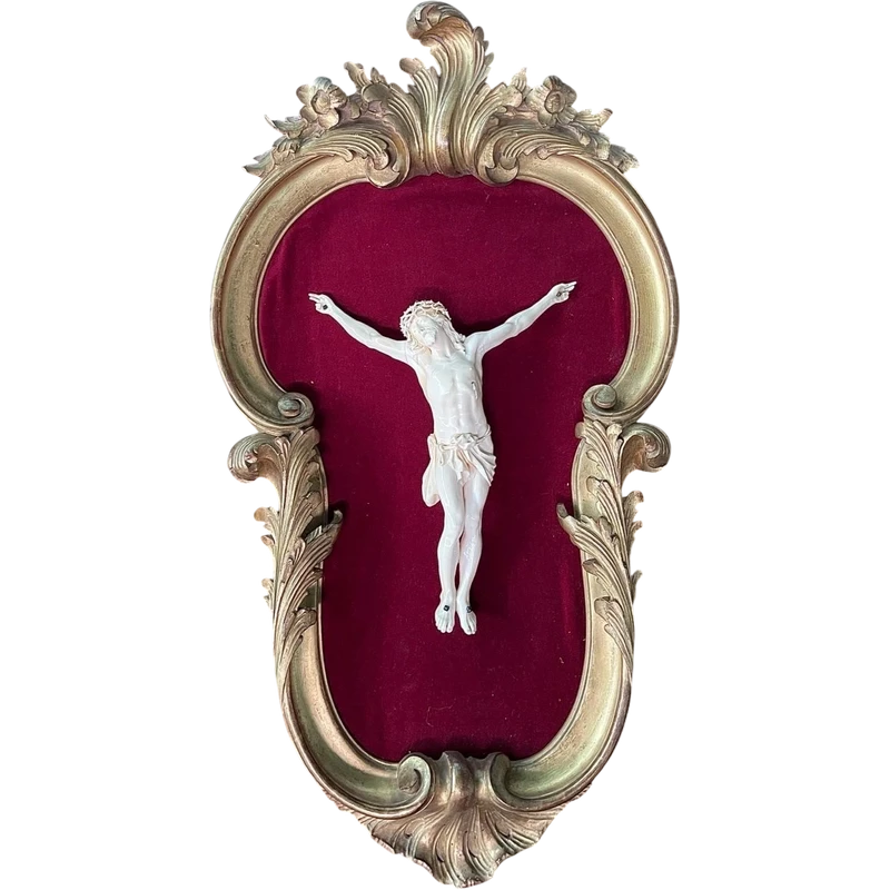 Cristo in avorio su cornice rocaille in legno dorato.