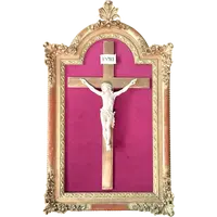 An ivory statue of Christ with a molded frame featuring floral motifs, rocaille, and gold leaf.