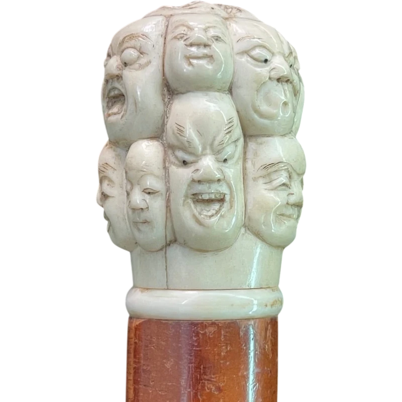 A walking stick with an ivory knob carved in the round with Commedia dell’Arte masks.