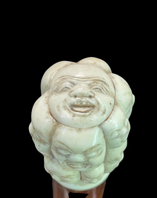 A walking stick with an ivory knob carved in the round with Commedia dell’Arte masks.