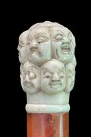 A walking stick with an ivory knob carved in the round with Commedia dell’Arte masks.