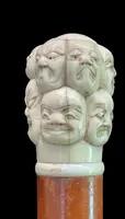 A walking stick with an ivory knob carved in the round with Commedia dell’Arte masks.