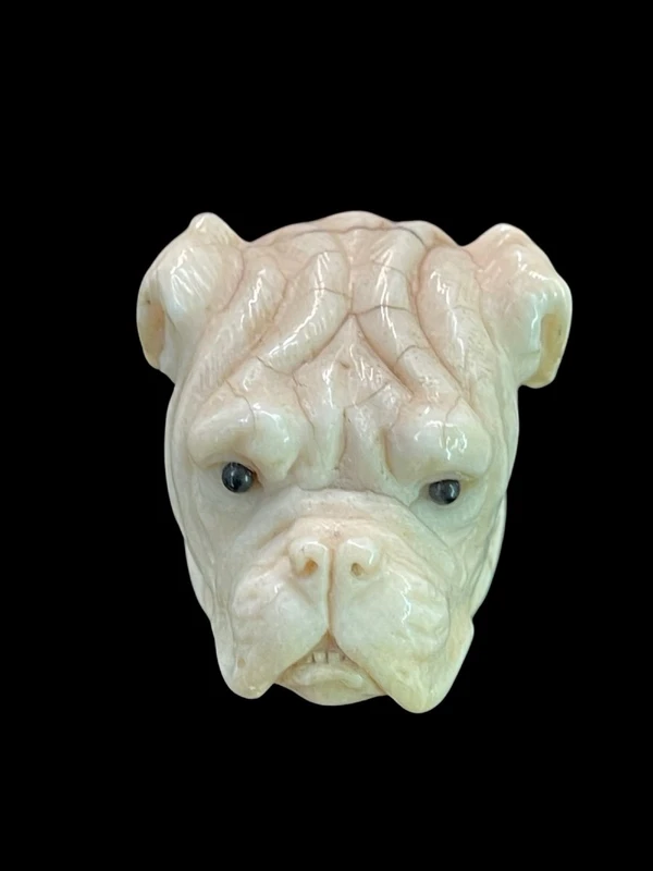 A walking stick with an ivory knob depicting the head of a Molosser dog.
