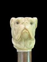 A walking stick with an ivory knob depicting the head of a Molosser dog.