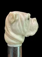 A walking stick with an ivory knob depicting the head of a Molosser dog.