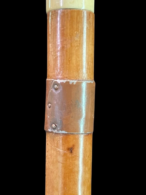 Cane with a round ivory knob carved with Commedia dell'Arte masks. Japan.